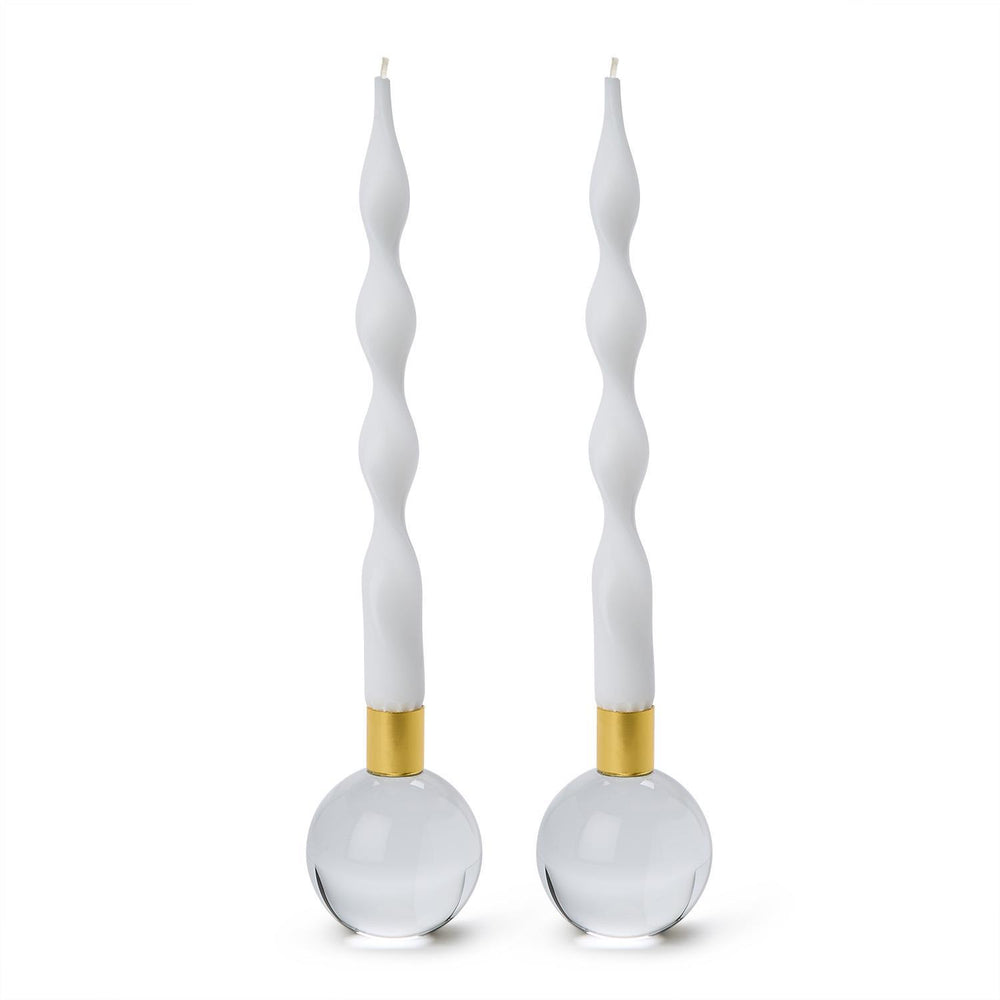 Studio photography of Jonathan Adler crystal orb candle holders on a white background featuring white twisted taper candles, gold-toned brass collars, and solid clear glass spherical bases