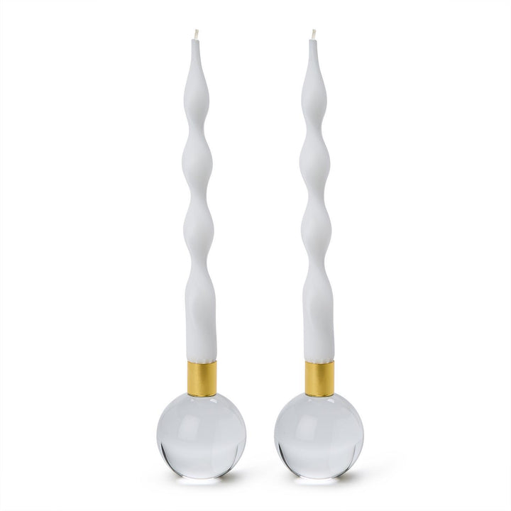 Two clear glass ball candleholders with gold collars holding white twisted taper candles