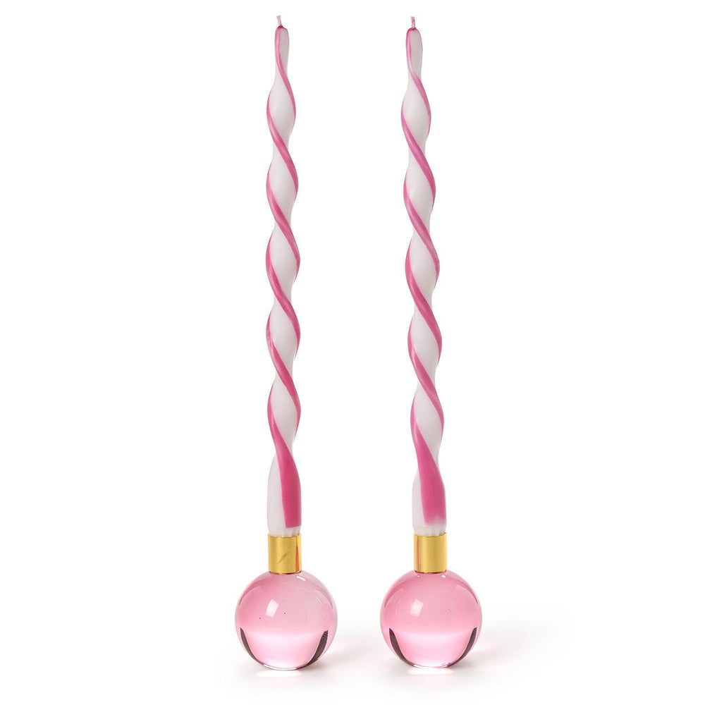 Hand-poured wax and glass art featuring two pink and white spiral-twisted taper candles standing in translucent pink spherical bases with gold-toned metal collars against a white background