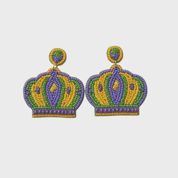 Seed bead embroidery Mardi Gras crown earrings featuring vibrant stripes of purple, emerald green, and golden yellow beads in a royal silhouette on a light gray background
