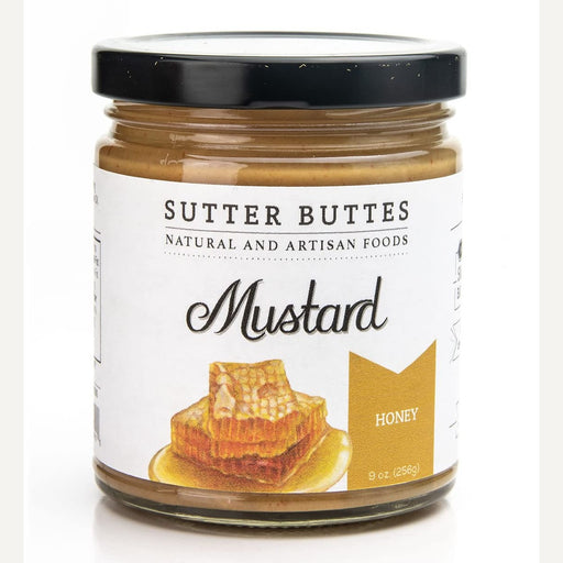Product photograph by Sutter Buttes of a glass jar of Honey Mustard against a white background featuring the iconic brand logo, a black lid, and a colorful illustration of golden dripping honeycomb