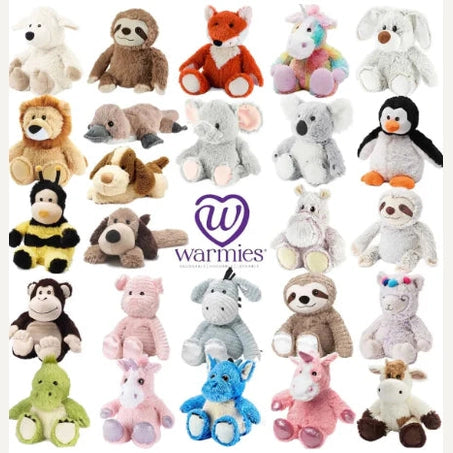 Product photography of Warmies brand plush toys features a grid of stuffed animals including a rainbow unicorn and a penguin on a white background with a fuzzy yellow bumblebee and a central purple heart logo
