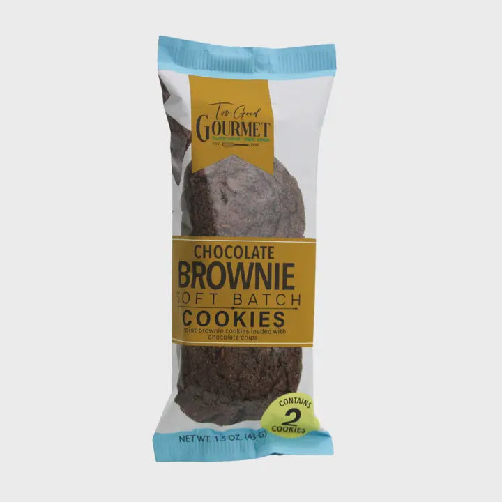 Product photography by Too Good Gourmet of Chocolate Brownie Soft Batch Cookies in a wrapper featuring light blue serrated edges, a gold brand banner, and a lime green two-count seal on a neutral background