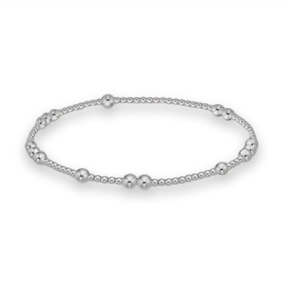 Sterling silver beaded bracelet featuring a polished reflective finish with alternating clusters of large and small spherical beads against a neutral white background
