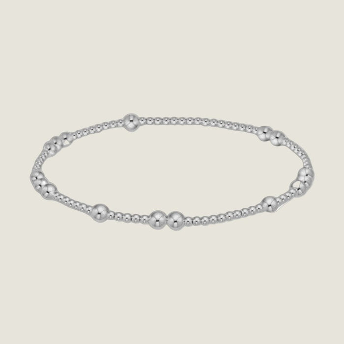 Sterling silver beaded bracelet featuring a polished reflective finish with alternating clusters of large and small spherical beads against a neutral white background