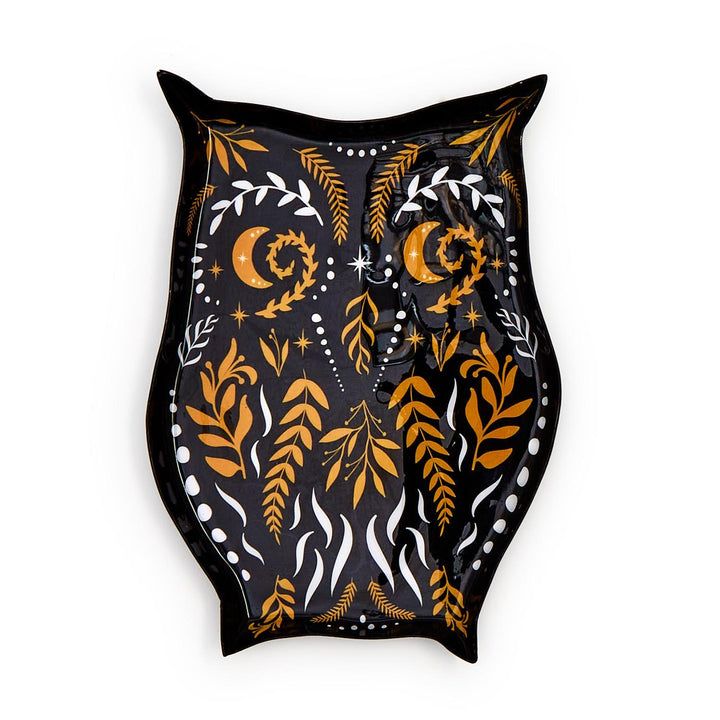 Black owl-shaped plate with orange and white folk-art leaves, moons and dots