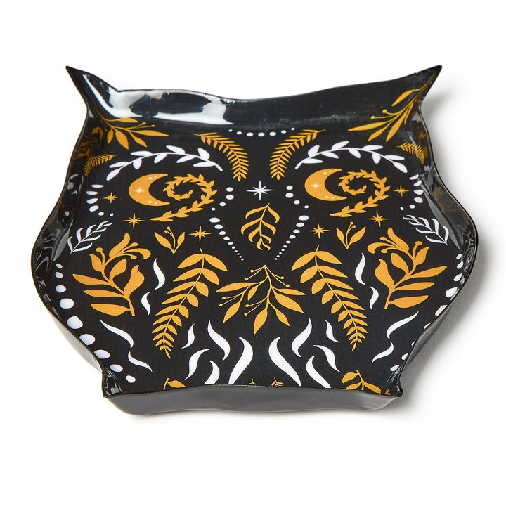 Angled view of a black owl-shaped plate with orange and white folk-art details