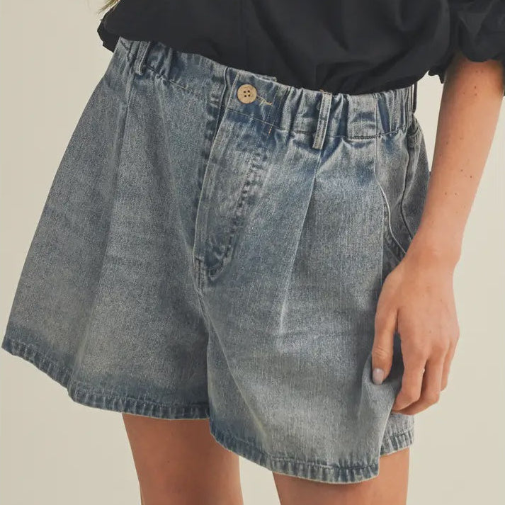 Vintage wash denim wide leg shorts with pleats, elastic waist and button, worn with a black top