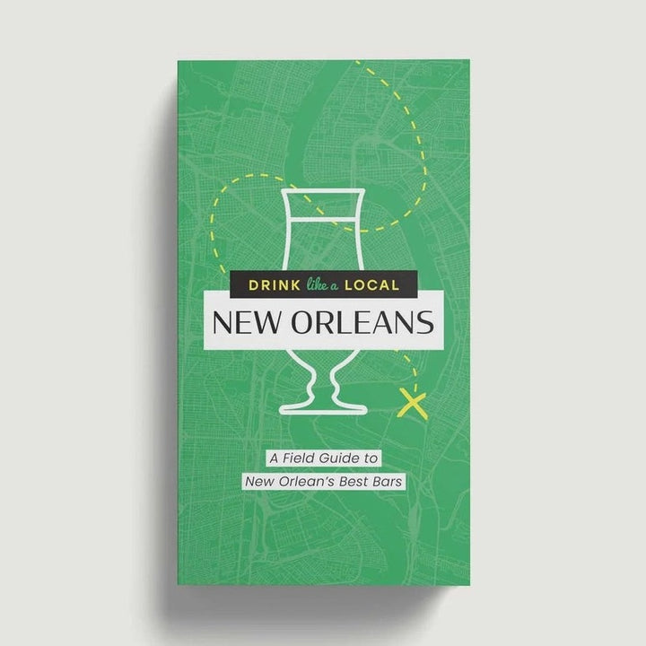 Digital graphic design of the Drink Like a Local New Orleans field guide book cover featuring a vibrant green city street map of the Mississippi River bend with white minimalist bar stool and cocktail glass icons and a yellow dashed path ending in an X