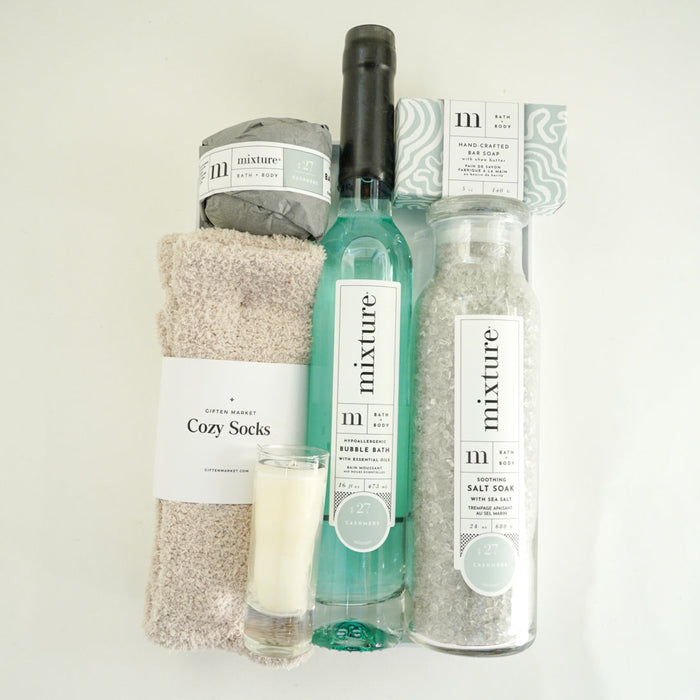 Set of bath products including a bottle, a jar, and a bag on a white background