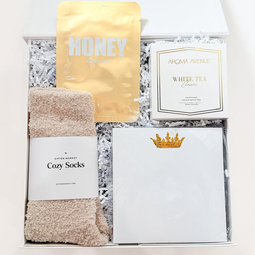 Gift box of self care with cozy socks and relaxation items.