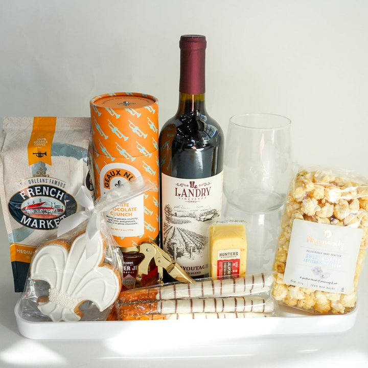Tray with wine, popcorn, and snacks on a white background