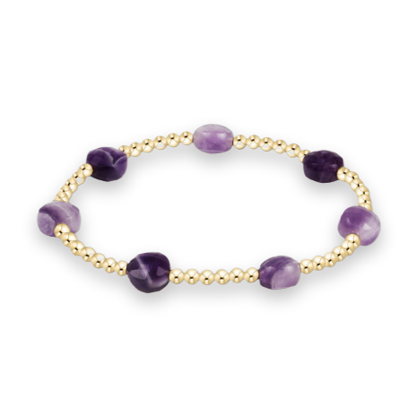 Amethyst and gold beaded jewelry bracelet on a white background featuring seven faceted purple gemstones with natural inclusions and polished yellow gold spherical beads