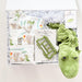 Green alligator-themed children's toy set with books and plush toy on a white background