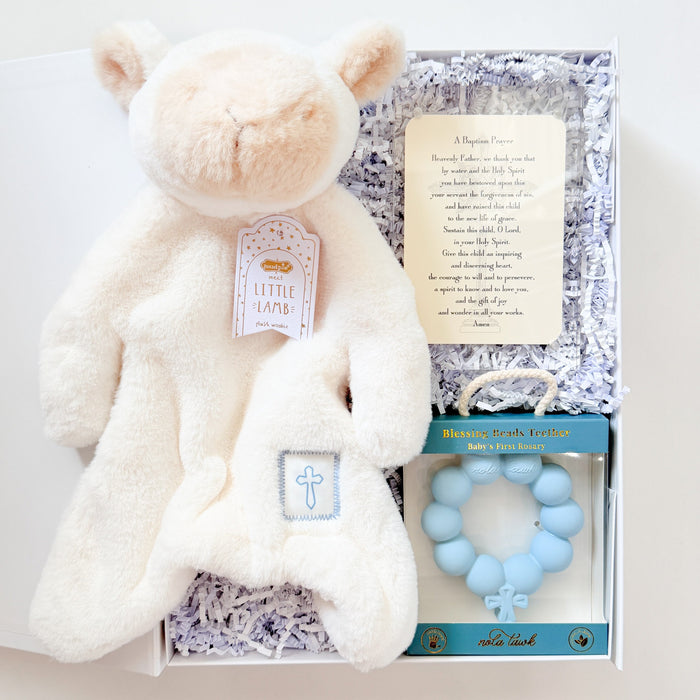 Baby gift set with white teddy bear, teething ring, and card on a white background