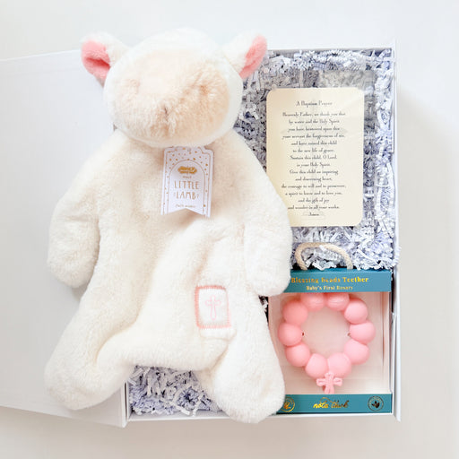 White plush toy with pink accents and a card on a white background