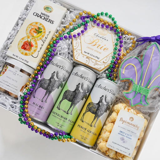 Gift set with drinks, snacks, and decorative items on a white background