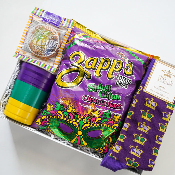 Mardi Gras-themed gift set with Zapp's chips, a mask, and socks on a white background