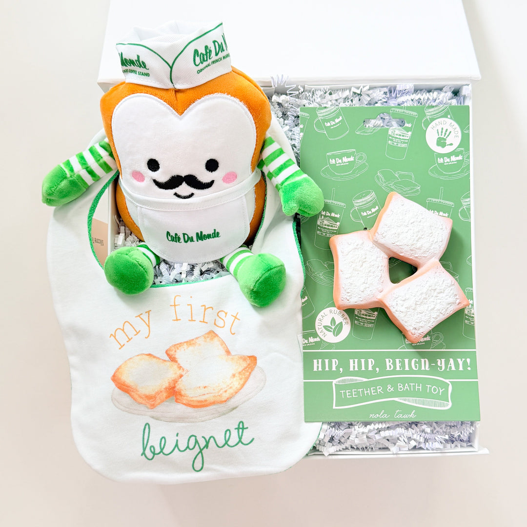 Plush toy resembling a beignet with packaging on a white background