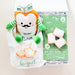 Plush toy resembling a beignet with packaging on a white background