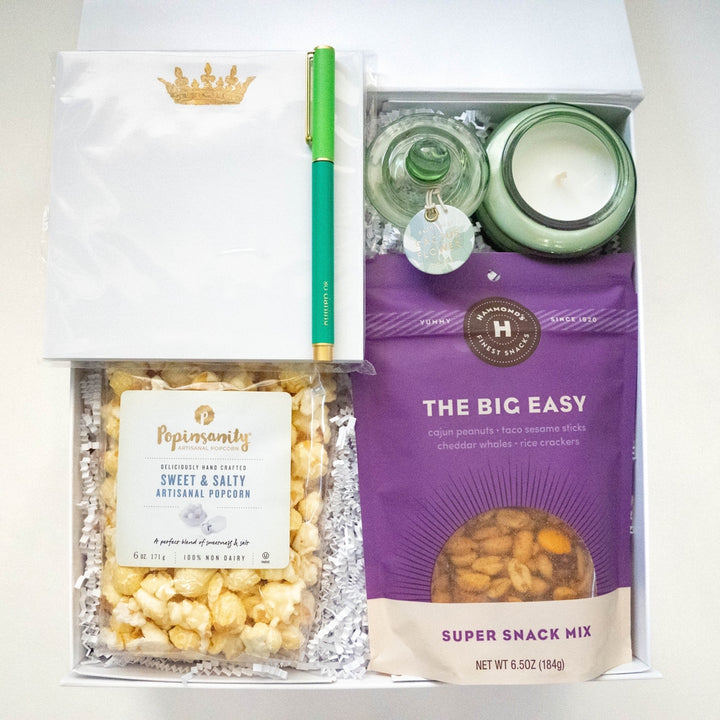 Photograph of a curated gift box containing a vibrant purple bag of Hammond&