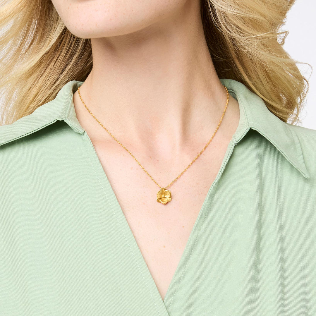 Photograph of a Michael Michaud gold hydrangea necklace worn on a woman&