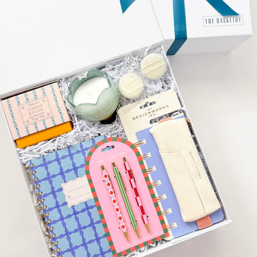 Gift set with stationery items and a decorative box on a white background