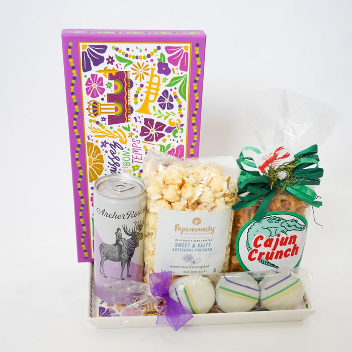 Gift tray with popcorn, candy, and a book on a white background