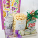 Gift tray with popcorn, beer, and bath bombs on a white background