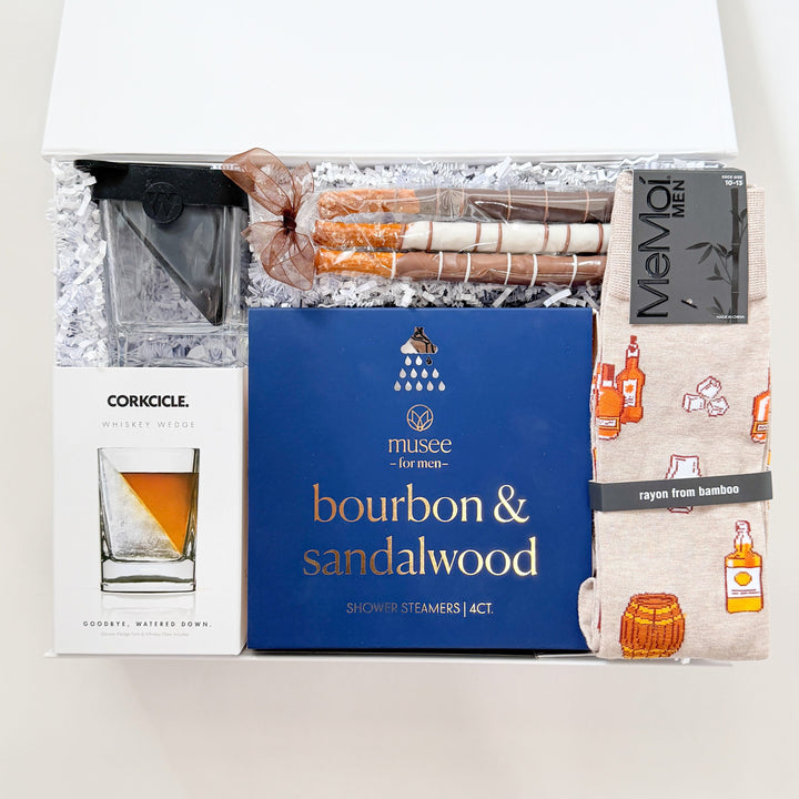 Box of bourbon and sandalwood shower steamers with branding on a white background