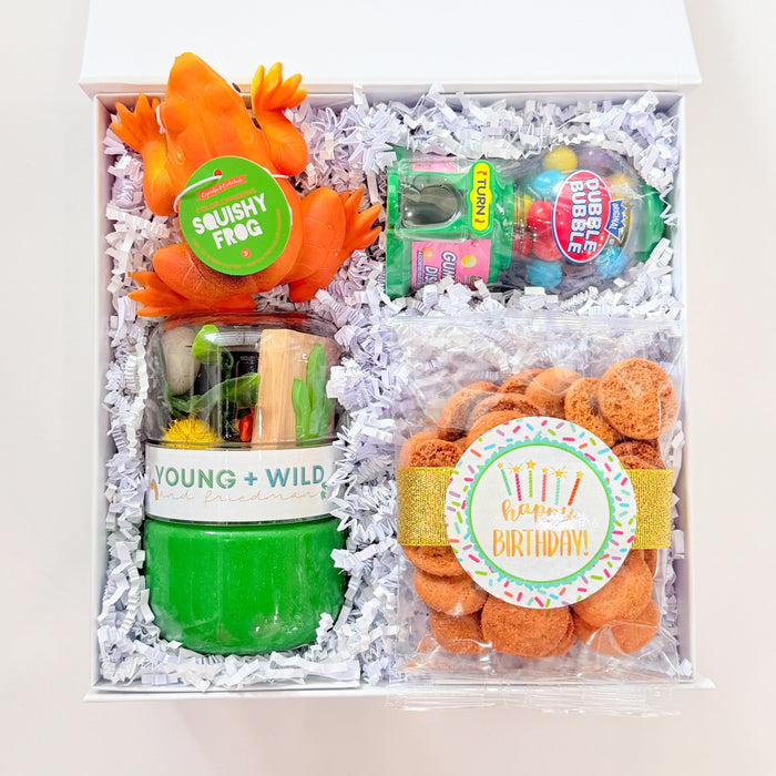 Gift set with gummy animals and candy in a box on a white background