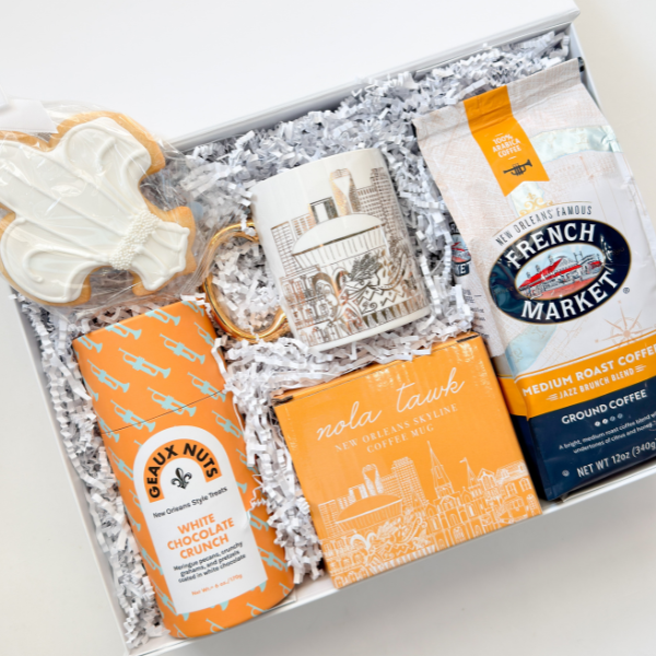 Gift box with cookies, coffee, and other items on a white background