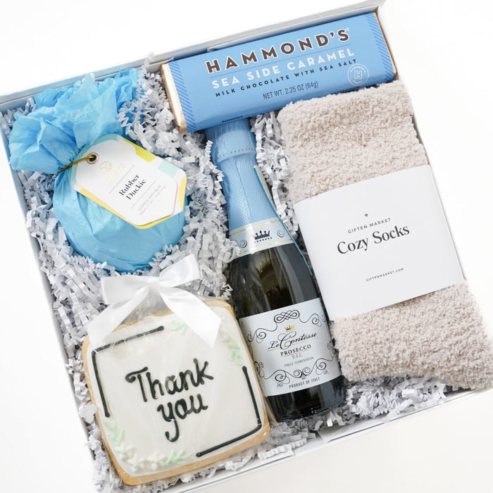 Gift set with a bottle of wine, cookies, and other items in a box.