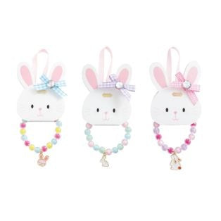 Product photograph of three pastel children's beaded bracelets with rabbit charms and coordinated gingham bows with central rhinestones displayed on white bunny-shaped cards against a plain background