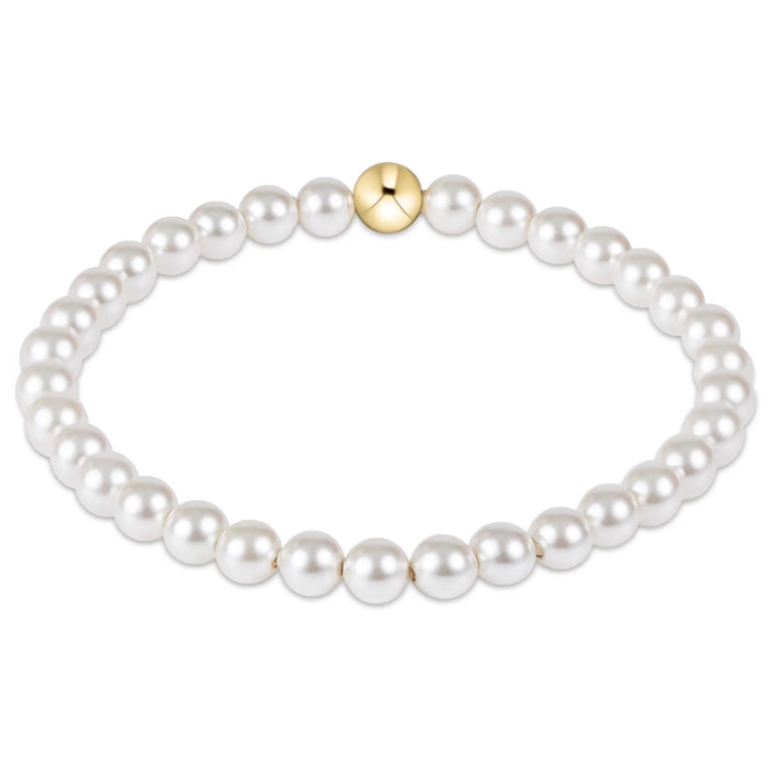 Pearl bracelet with a gold clasp on a white background