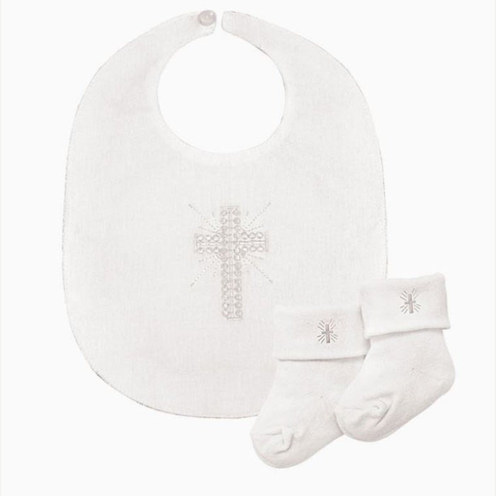Product photograph of a white cotton Christening set featuring a baby bib and matching socks displayed on a plain background with an intricate shimmering beaded cross and small embroidered religious motifs on the folded cuffs