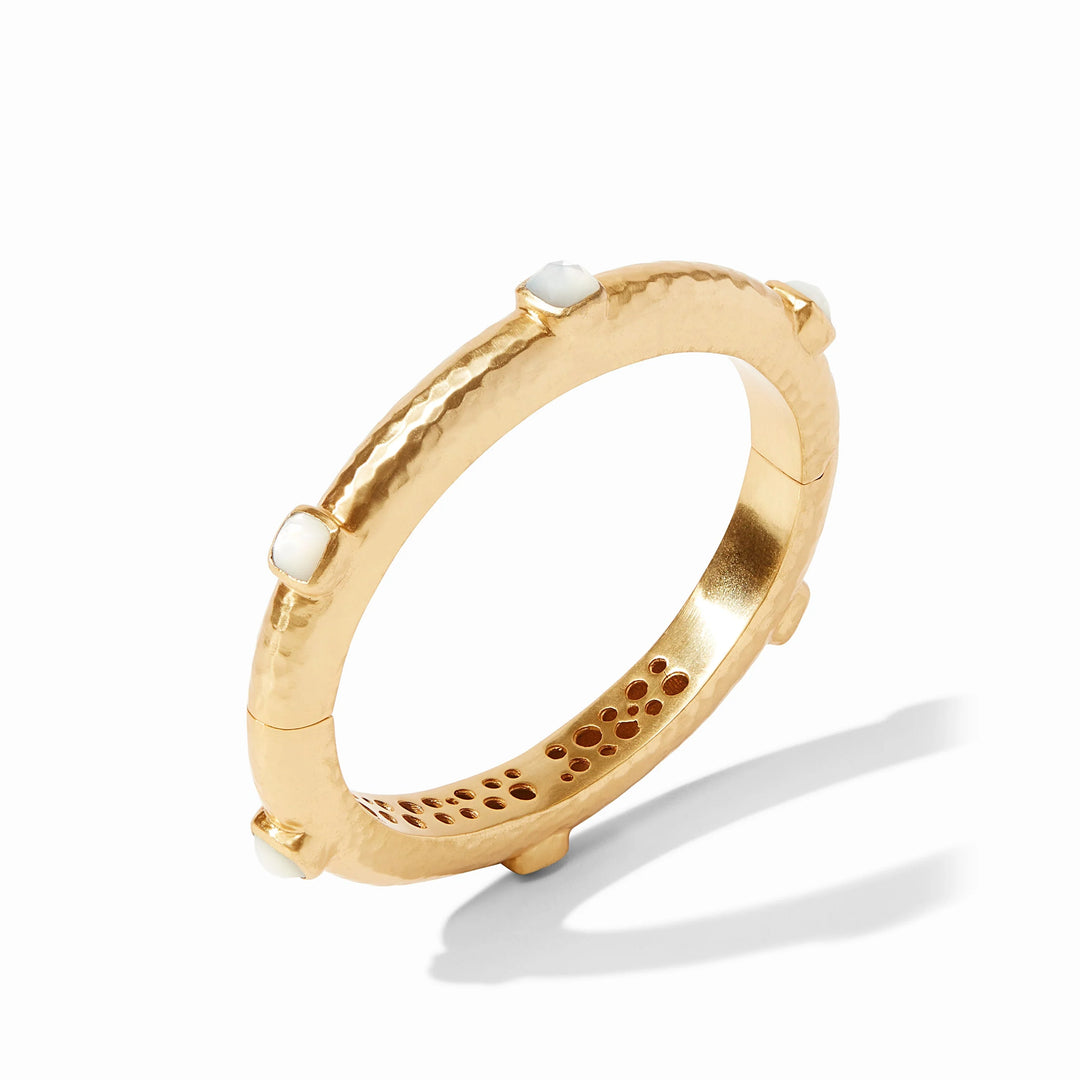 24k gold plated hammered metal bangle by Julie Vos featuring iridescent square mother of pearl stones and a decorative cutout interior pattern on a white background