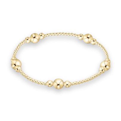 Gold-filled beaded jewelry showcases a circular stretch bracelet on a white studio background featuring five symmetrical clusters of polished spheres, alternating bead diameters, and a reflective metallic gold finish