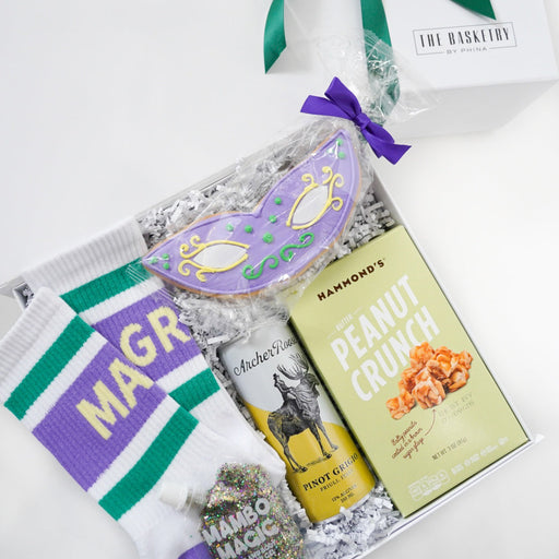Gift basket with snacks, cookies, and a book on a white background