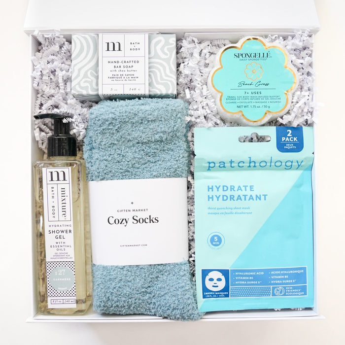 Gift set with bath items including soap, towel, and packaging on a white background