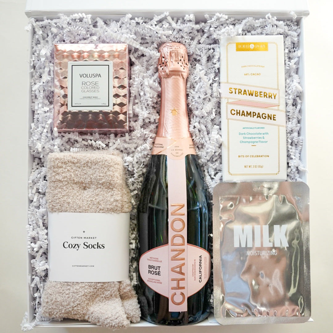 Gift set with Chandon champagne, cozy socks, and other items in a box.
