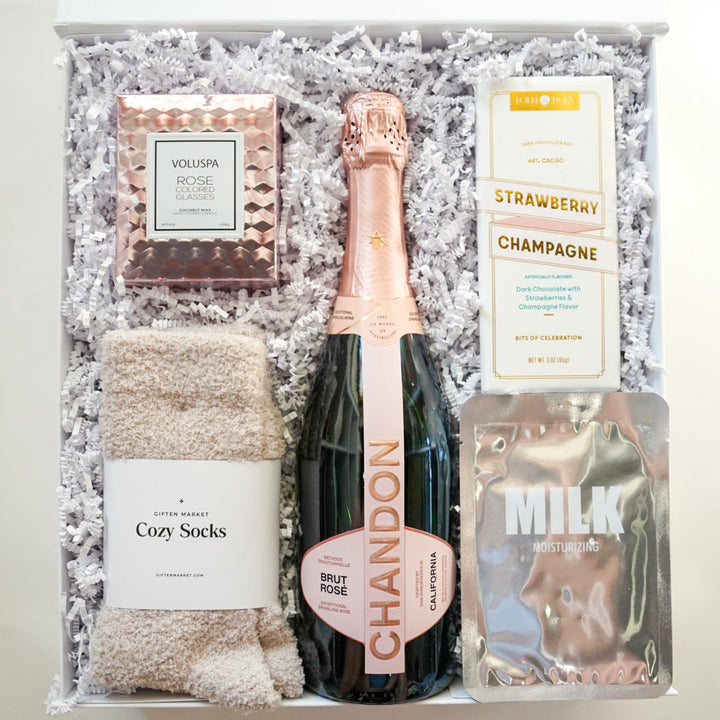 Gift set with Chandon champagne, cozy socks, and other items in a box.
