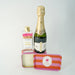 Bottle of champagne, matches, and a striped box on a white background