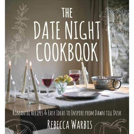 Book cover photograph by Rebecca Warbis of a romantic dinner table setting featuring glasses of red wine, slender white taper candles in glass bottles, and a small vase of yellow flowers on a linen tablecloth