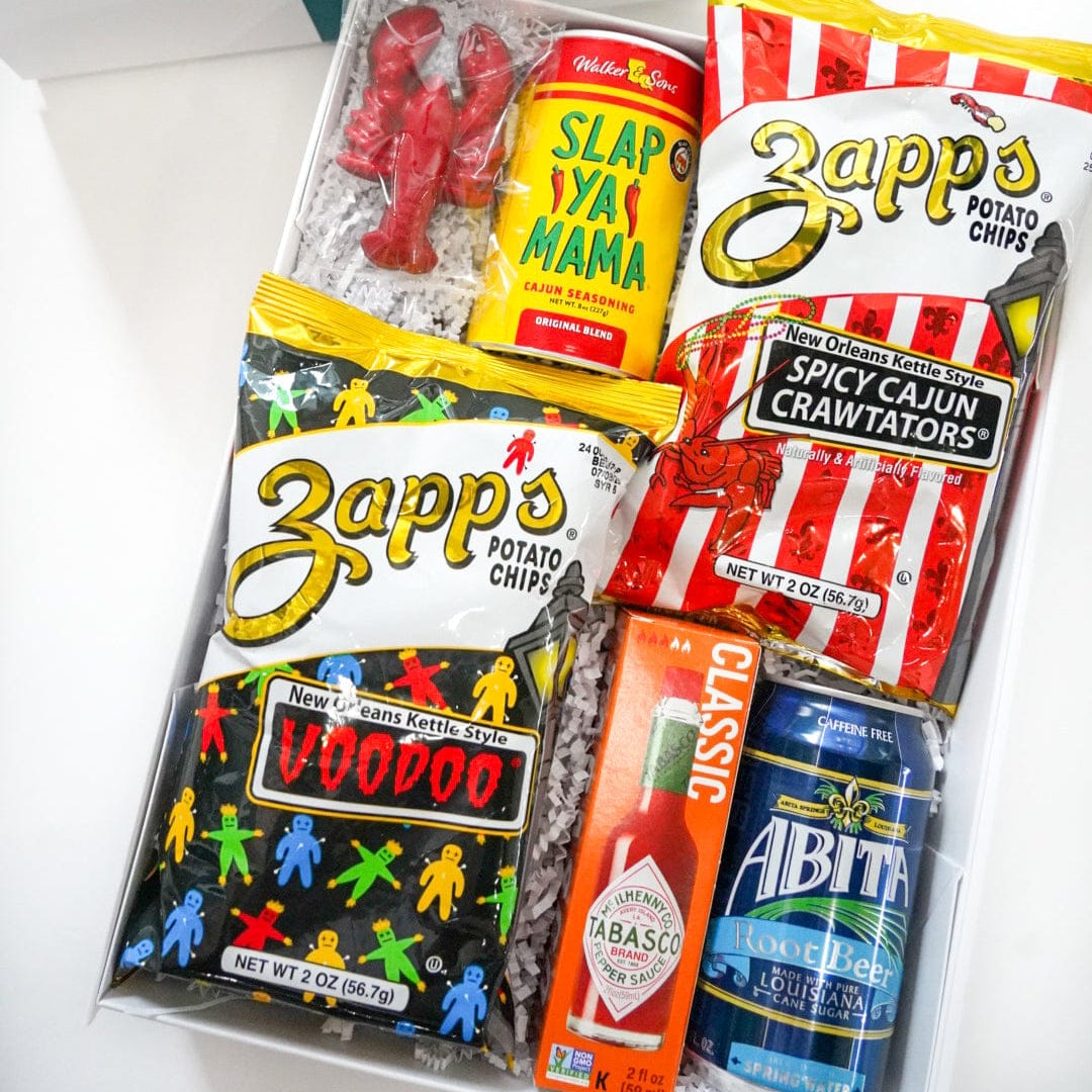 Gift box with snacks and drinks including Zappos, Slap Ya Mama, and ABita beer.