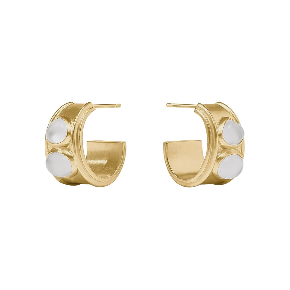 Gold jewelry by Julie Vos featuring wide Byzantine hoop earrings inlaid with iridescent milky white cabochons and detailed with textured gold borders on a white background