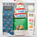 Gift box with birthday-themed items including socks, snack mix, and a cake-shaped cookie.