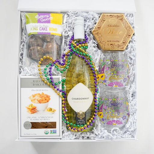 Gift basket with wine, snacks, and decorative items on a white background