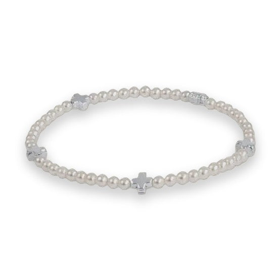 Silver-tone beaded bracelet centered on a light grey background featuring four equidistant polished cross charms and uniform metallic round beads with a reflective finish