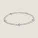 Silver-tone beaded bracelet centered on a light grey background featuring four equidistant polished cross charms and uniform metallic round beads with a reflective finish
